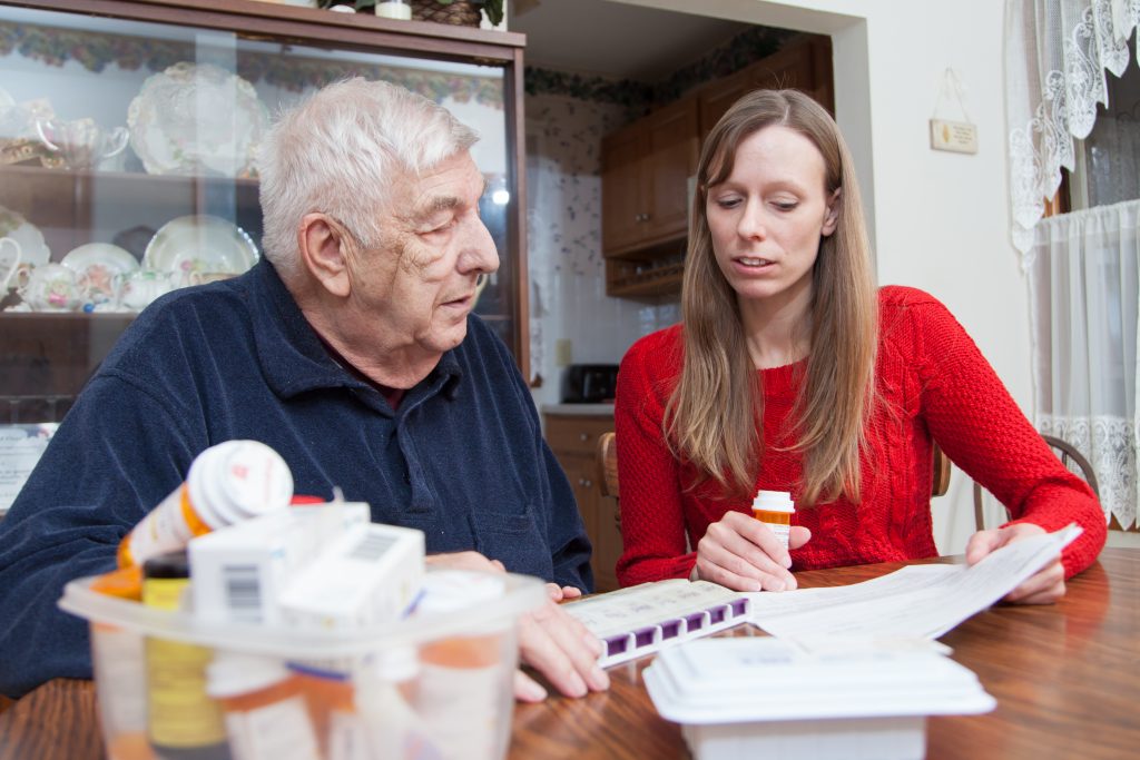 Tonya Roberts looks over papers with older patient.