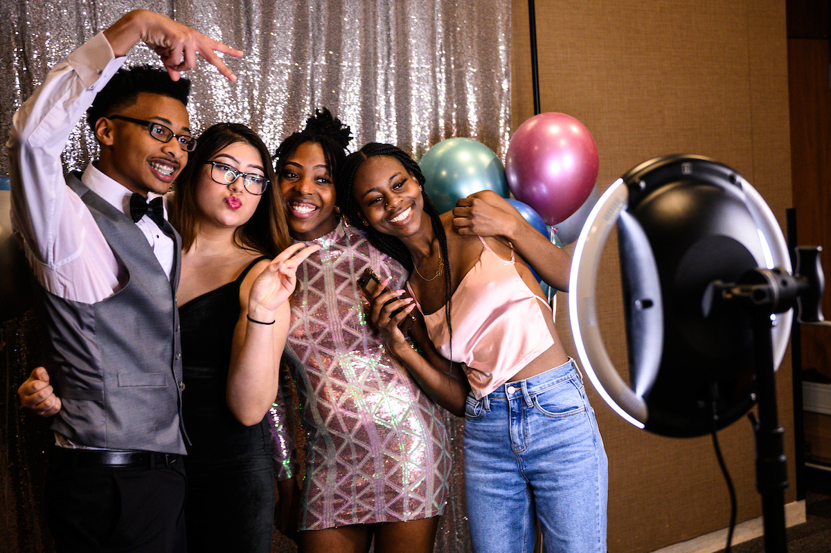 A group of students pose for a photo at a Black History Month kickoff event, called “An Afrofuturist Affair."