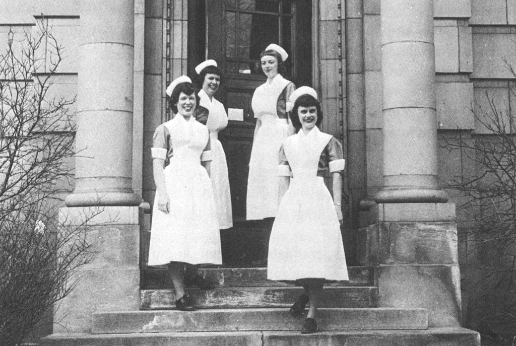 The first class at the School of Nursing stands on the steps of the old dormitory