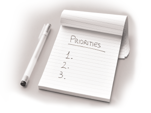 A notebook and pen with the word "priorities."