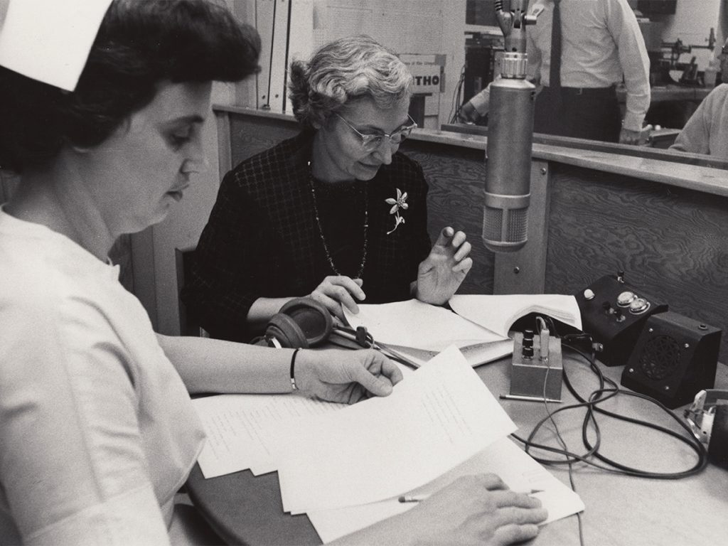 Signe Skott Cooper looks over papers as she prepares to go on the radio. 