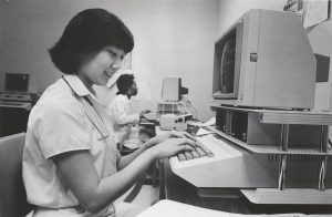 A nursing student works on a computer, circa 1985.