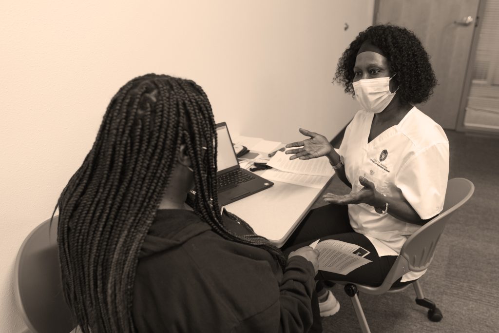 A student works with a community member to gather data for Nurses 4 Black Well-Being research in July 2022.