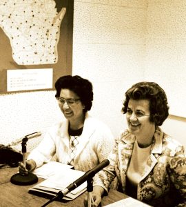 May Hornback, Cert’53, ’54, (left) and Ruth Schumacher Lutze, Cert’51, ’52 (right) take part in a radio teleconference on nursing techniques for inactive nurses, circa 1970. The location dots on the map in the background represented areas where listeners were tuning in.