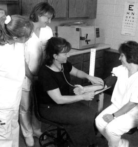 A NET student demonstrates the proper way to take blood pressure to students at Nicolet College in Rhinelander, Wisconsin in 2002.