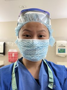 Julie Jones in scrubs and mask