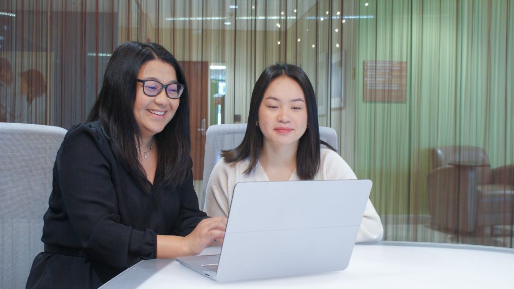 Maichou Lor, PhD, RN, conducts research with a graduate student.