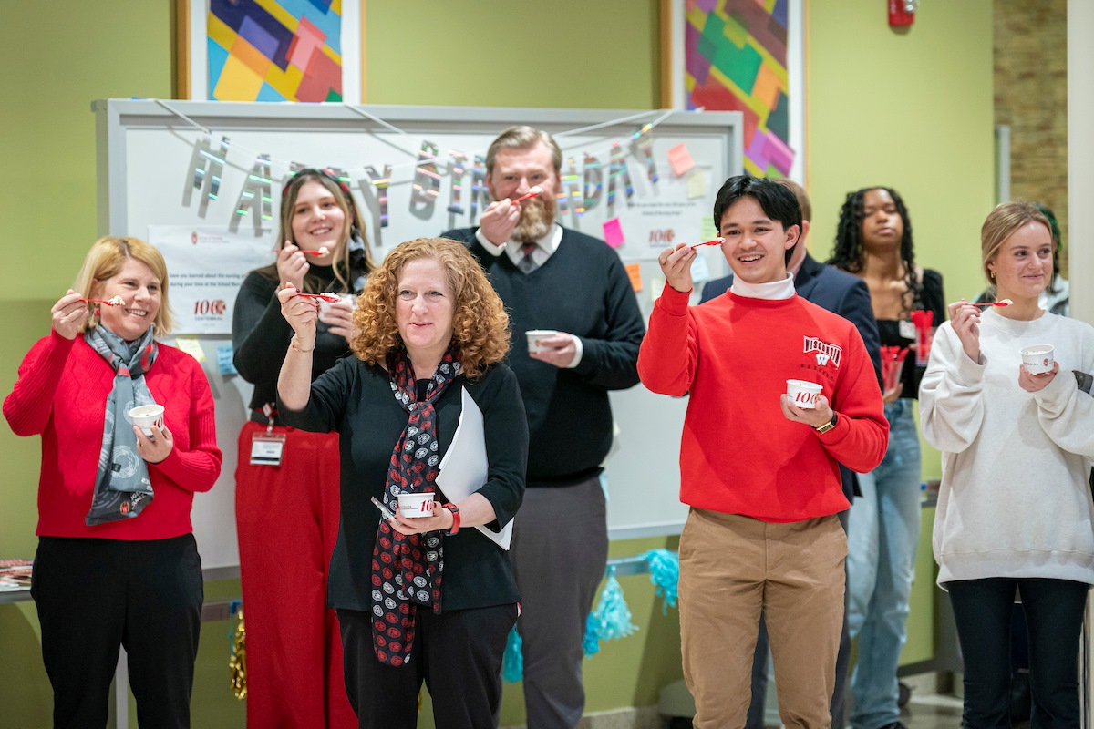Chancellor Jennifer Mnookin raises her ice cream spoon in a toast alongside School of Nursing students, alumni, faculty, and staff.