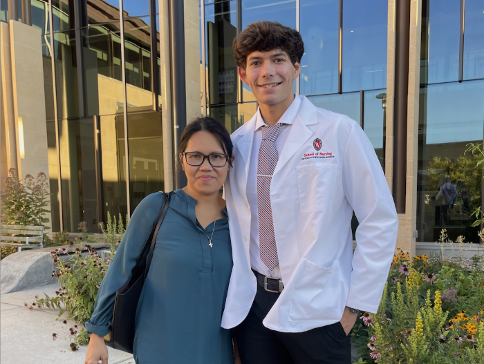 Spencer Meyer in his white coat outside Signe Skott Cooper Hall