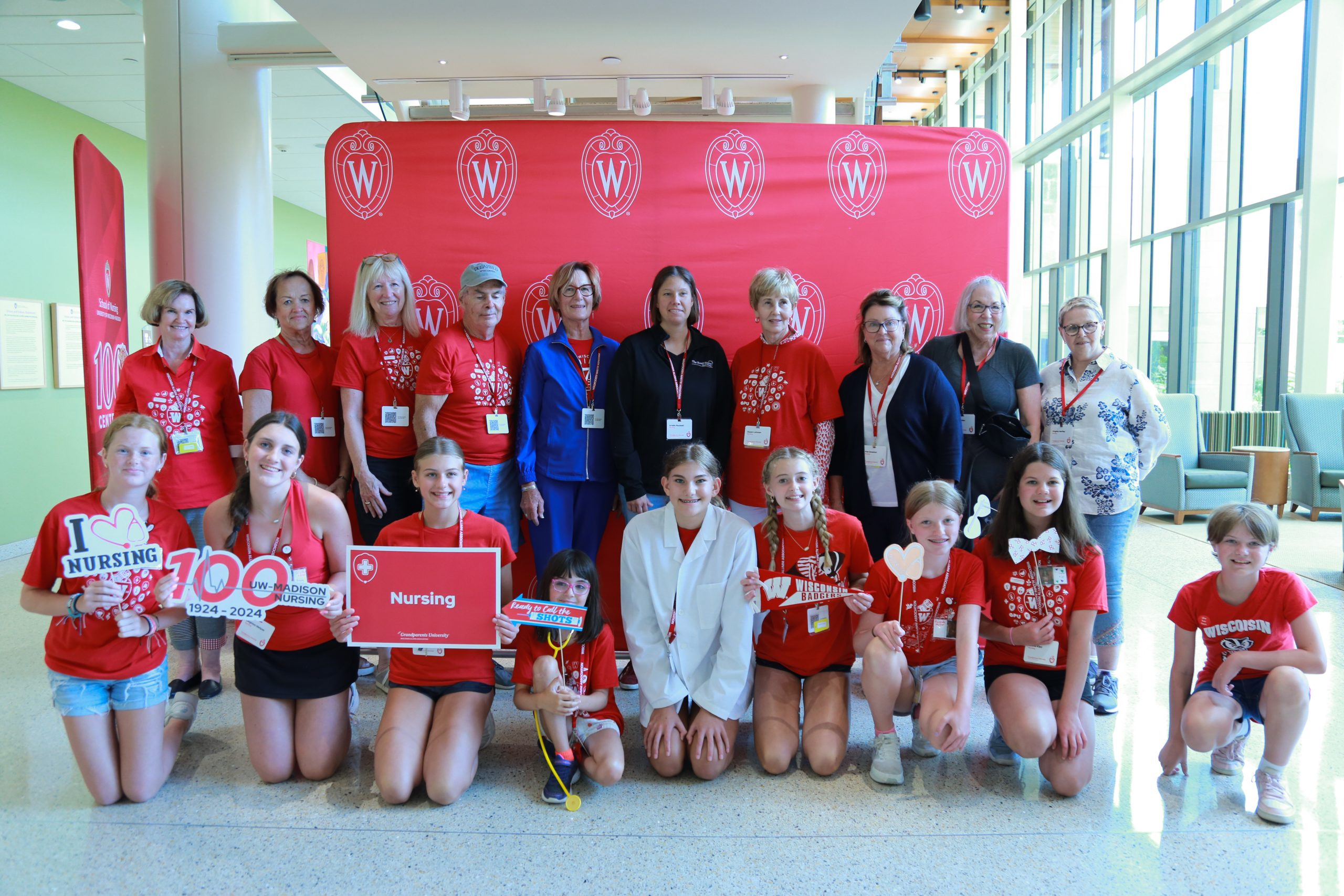 Adults and kids participating in Grandparents University pose at the School of Nursing.