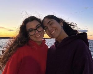 Rachelle and her sister at sunset on a beach.