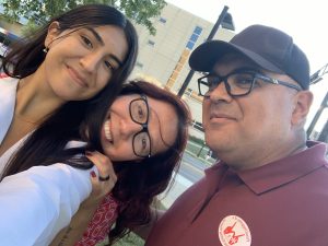 Rachelle strikes a post with her parents.