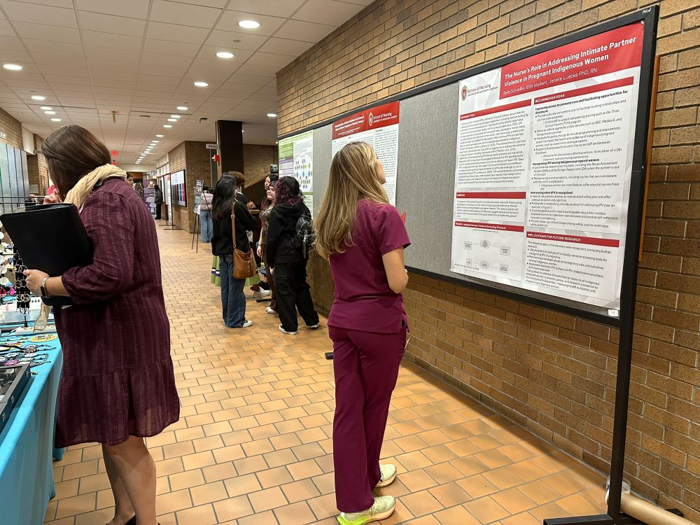 A participant reads one of the poster presentations at the Native Nations Nurses, Helpers, and Healers Summit.