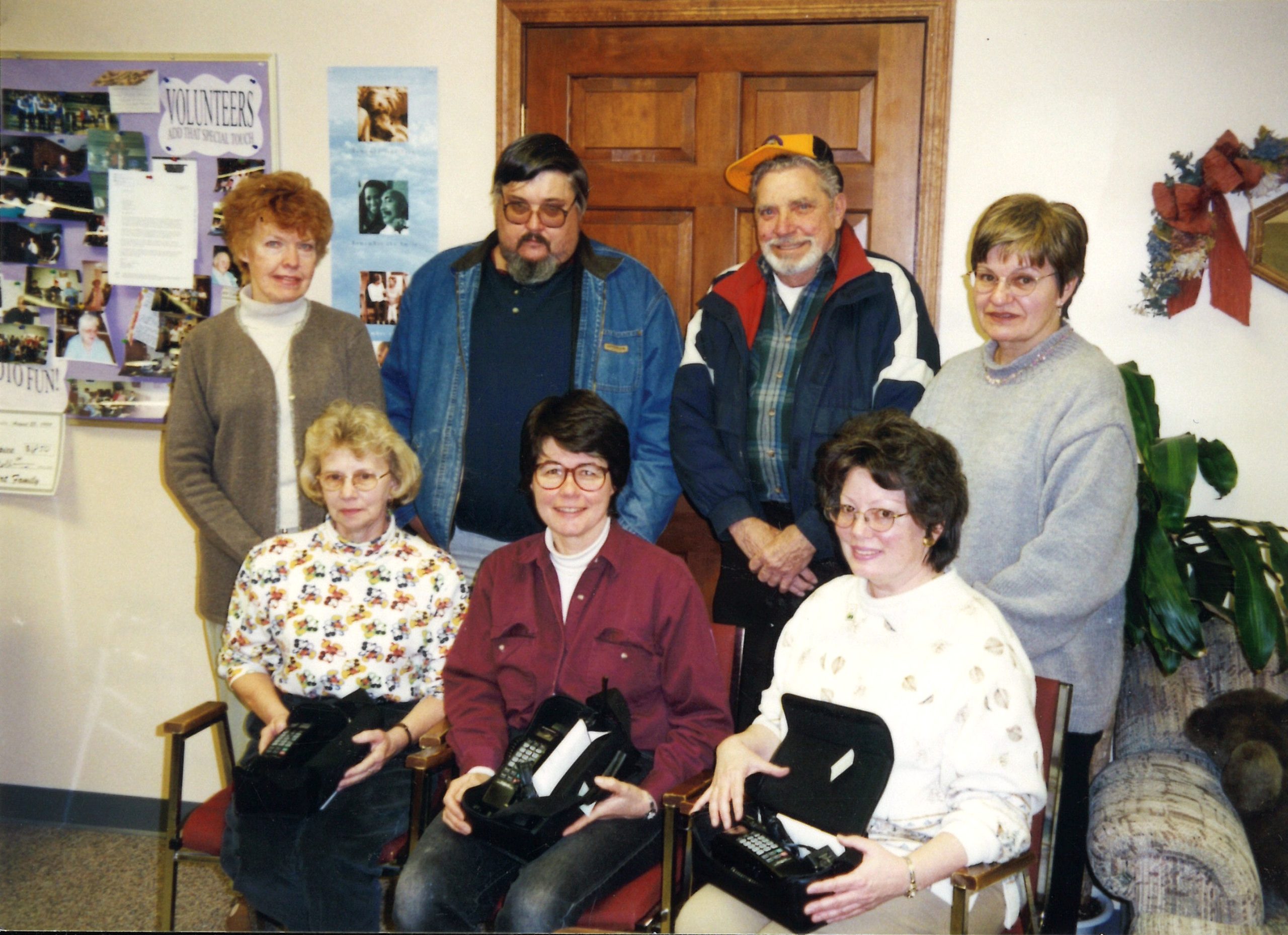 Meyer and her staff pose with three gigantic cell phones, circa 1999.