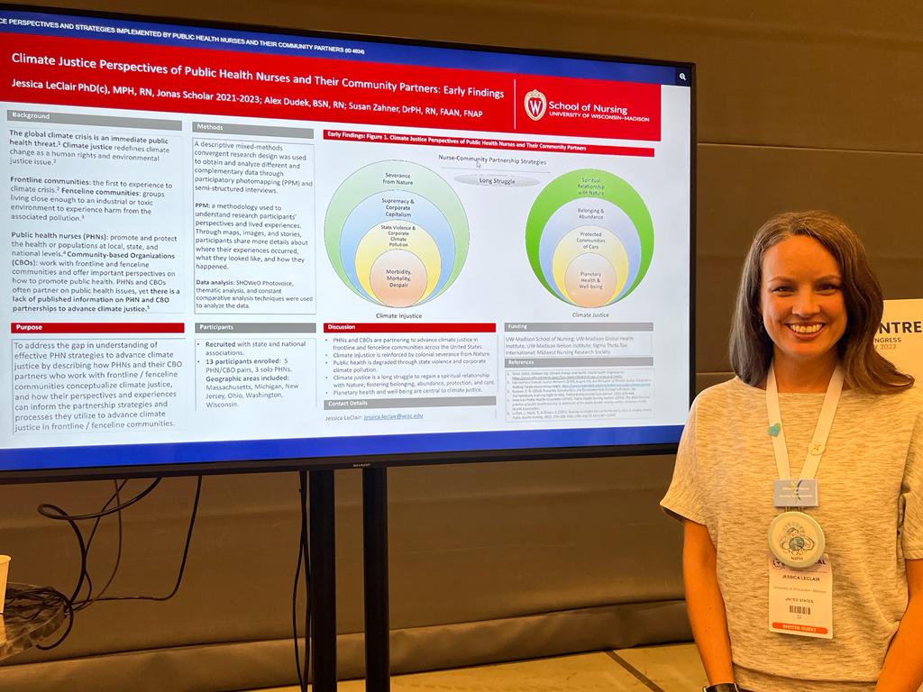 LeClair stands next to her poster presentation, titled: Climate justice perspectives of public health nurses and their community partners.