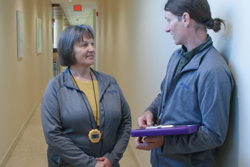 Professor Barb King and a PhD student discuss the results of a research project.