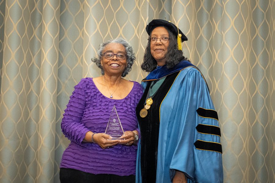 Edith Lawrence-Hilliard receives the Canary Savage Girardeau award from Dean Linda D. Scott.