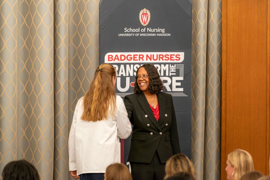 Dean Linda Scott shakes the hand of an incoming TBSN student during the annual White Coat Ceremony.