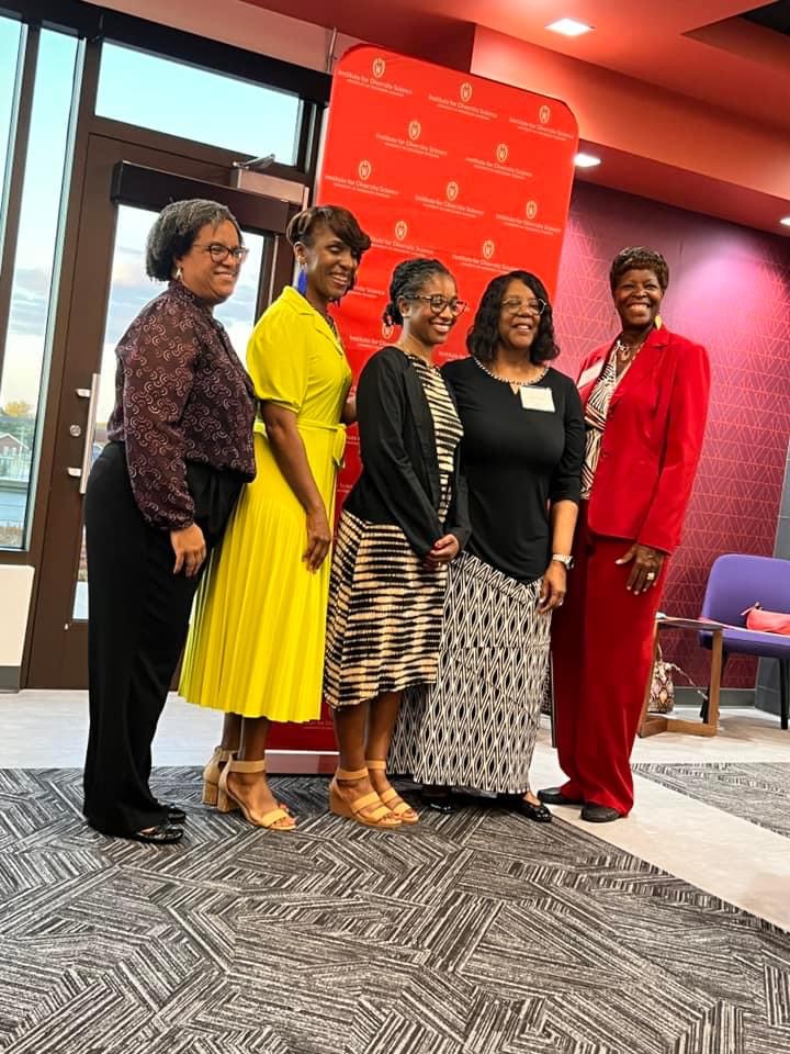 Dean Emerit Scott poses with colleagues at a conference.