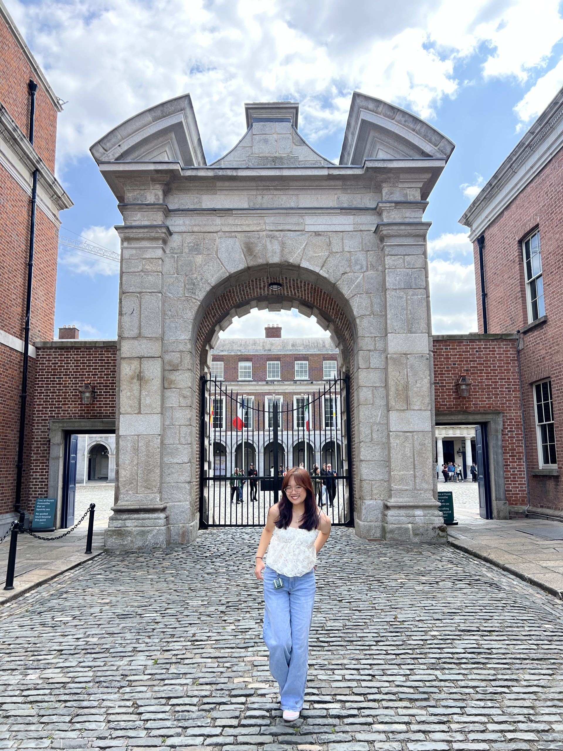 Carmela De Leon stands in front of a giant stone archway during her immersion trip to Ireland.