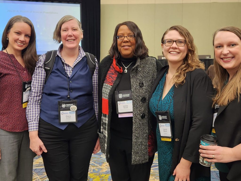 Linda D. Scott with PhD students and postdocs at the MNRS conference in 2023.