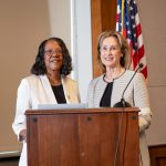 Lnda D. Scott and Deb Trautman stand at a podium together.
