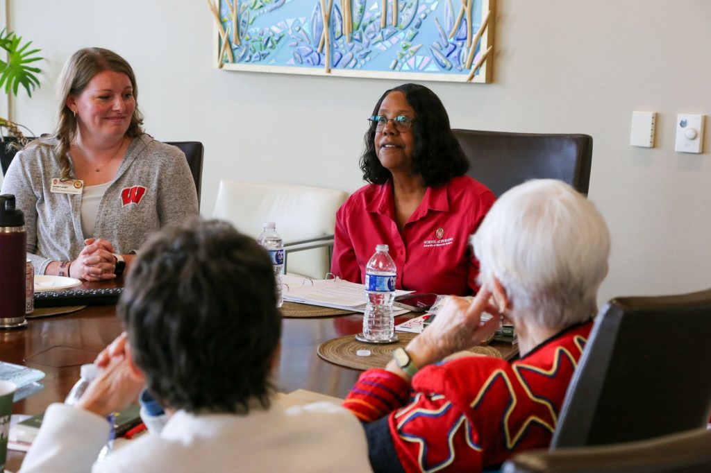 Jordan Langer listens as the late Dean Emerit Linda D. Scott speaks to a group of alumni.