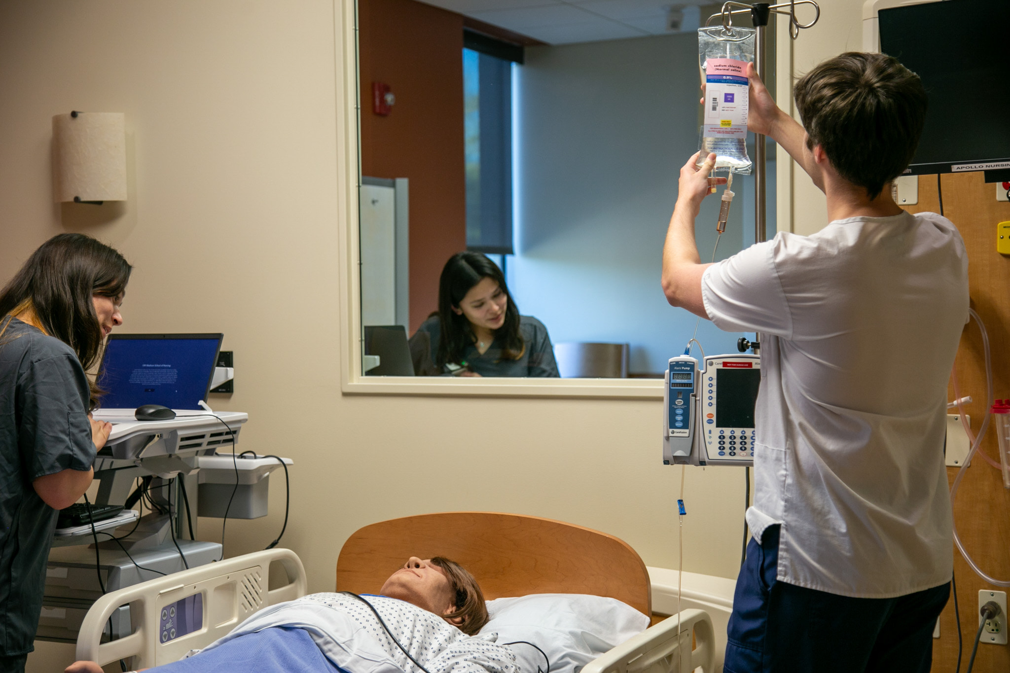 Students practice clinical skills on a medical mannequin in the Shapiro Hospital Suite in the Center for Technology Enhanced Nursing in Cooper Hall.