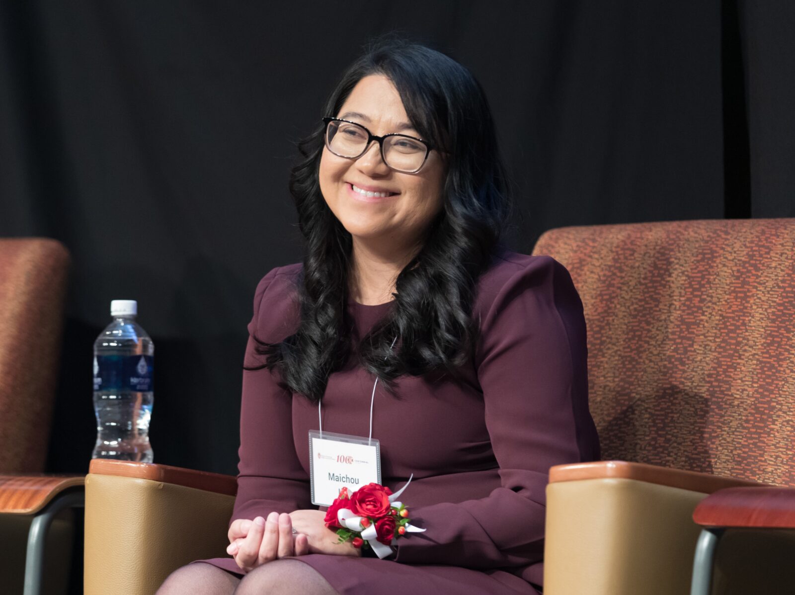 Dr. Maichou Lor smiles at the audience during a presentation.