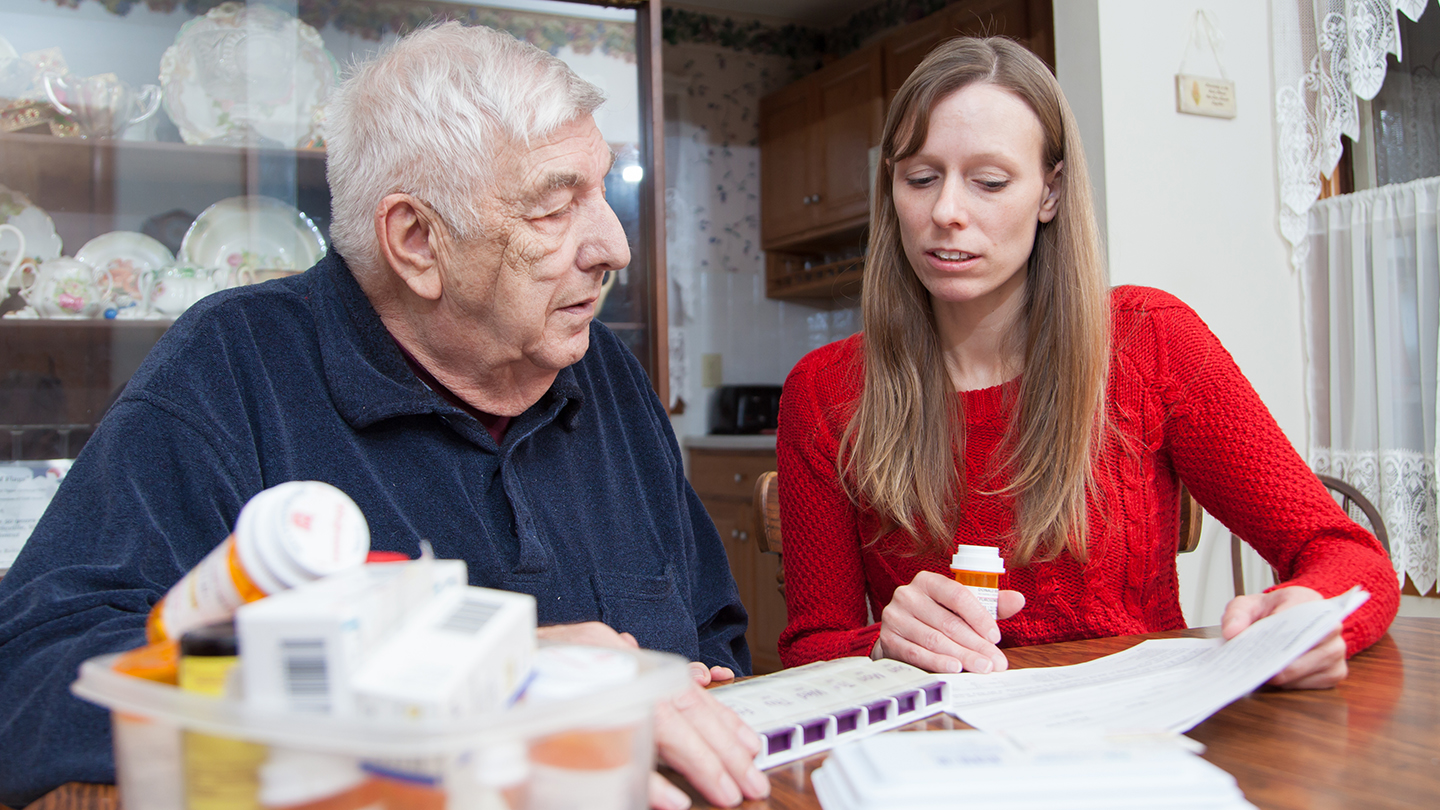 Tonya Roberts looks over papers with older patient.