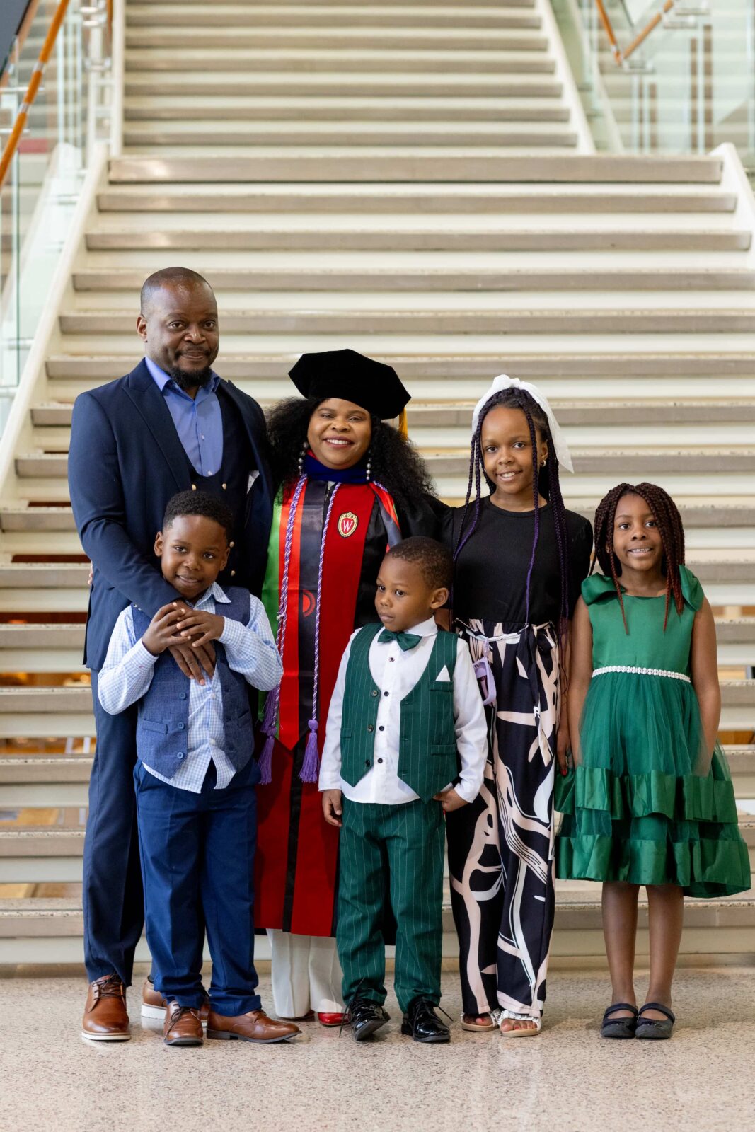 Yamikani Bridget Nkhoma-Mussa, PhD'26, with her family after the Doctoral Hooding Ceremony.