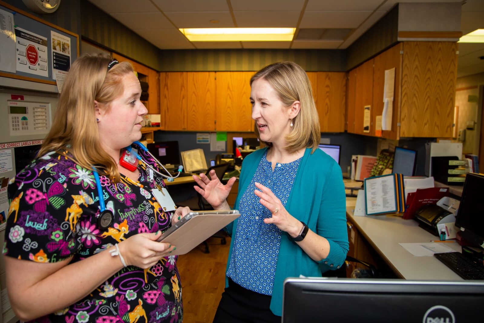 Linsey M. Steege, PhD, conducts health systems research at a hospital. She asks a nurse in colorful scrubs about her experiences.